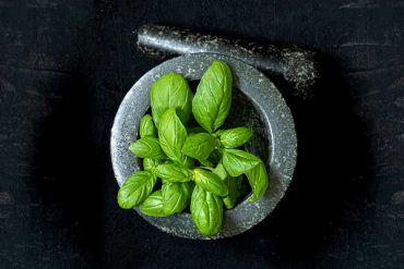 Basil in a mortar and pestle